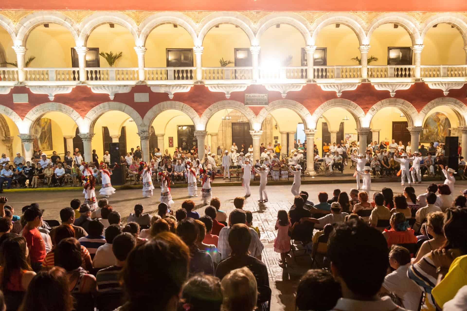 Night festival with dancing in national costumes and poetry reading near of municipal palace (palacio municipal) in merida, yucatan, mexico